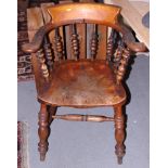 A "Captains" spindle back elbow chair, on turned and stretchered supports