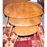 A nest of three Ercol pebble tables, the largest 26" wide