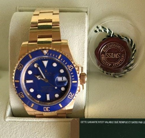 A 2009 18ct gold Rolex Oyster Perpetual Submariner wristwatch, complete with box and paperwork,