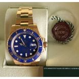 A 2009 18ct gold Rolex Oyster Perpetual Submariner wristwatch, complete with box and paperwork,