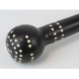 An ebony swagger stick with inset ivory