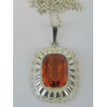 A silver and citrine pendant, large oran