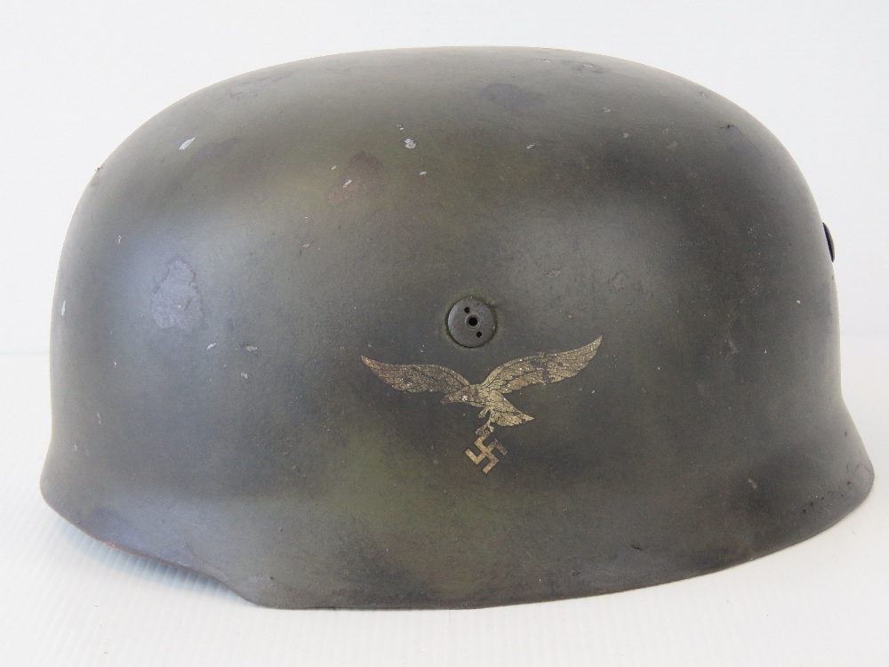 A WWII German Luftwaffe Paratrooper helmet, later painted having applied decal,