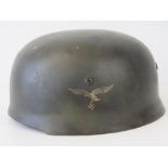 A WWII German Luftwaffe Paratrooper helmet, later painted having applied decal,