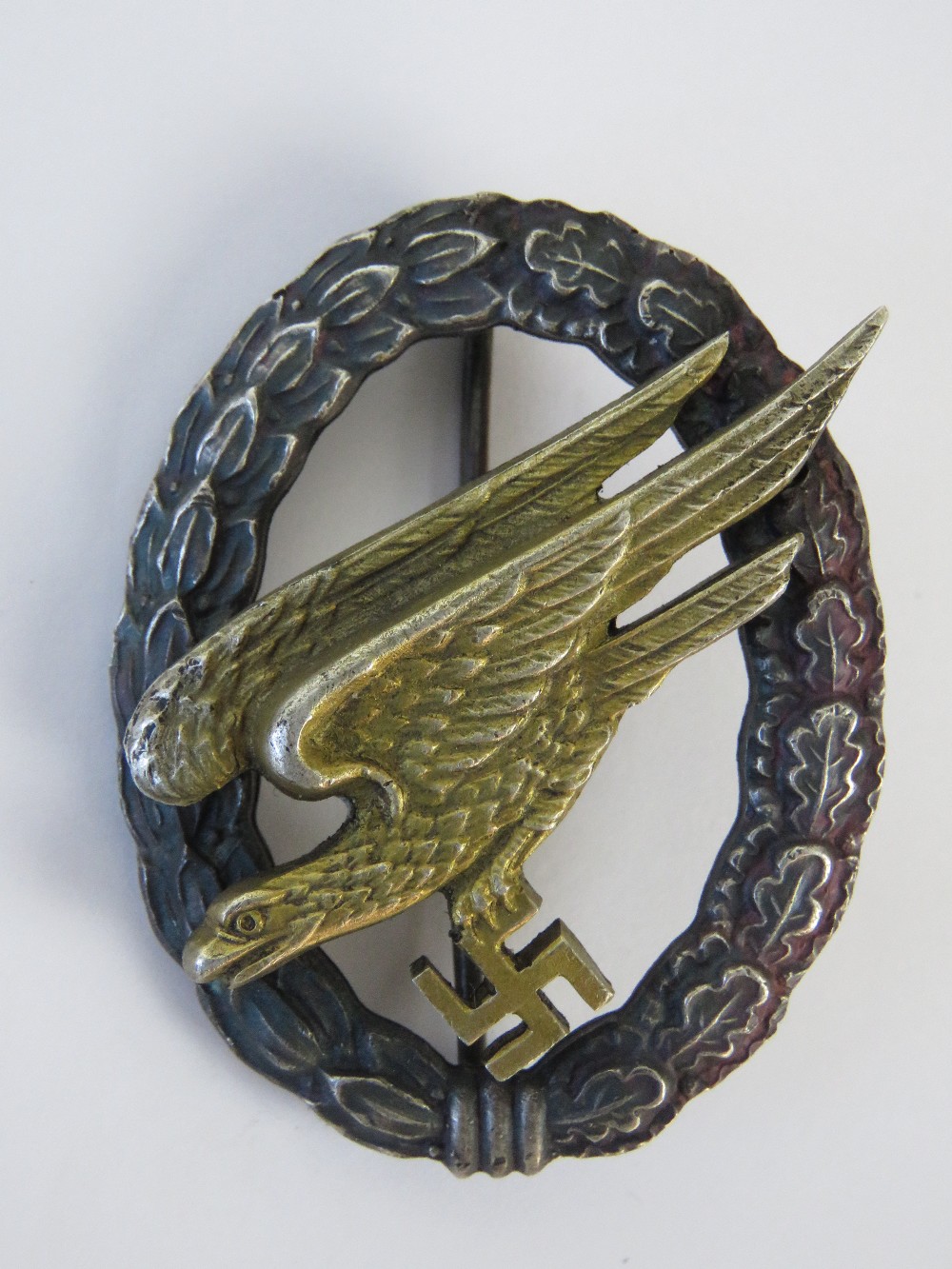 A WWII German Paratrooper 'Gold Eagle' badge.