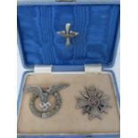 A German Third Reich Pilots breast badge and a Knights Cross with swords, in presentation case.