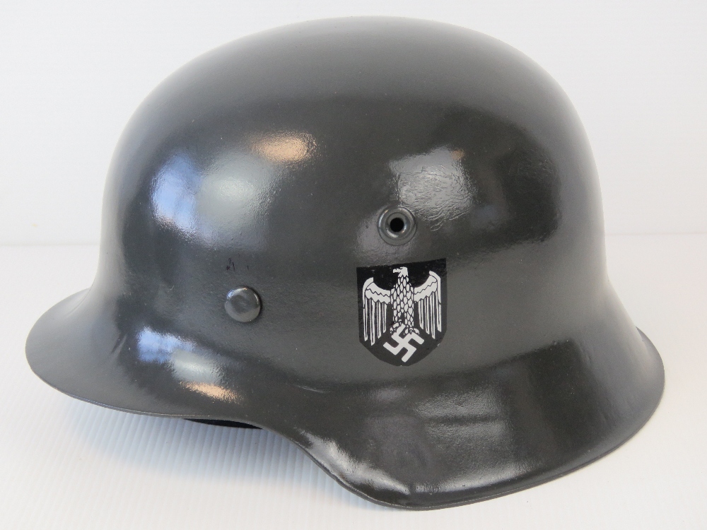 A good reproduction WWII German Army helmet with leather liner and chin strap.