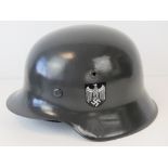 A good reproduction WWII German Army helmet with leather liner and chin strap.