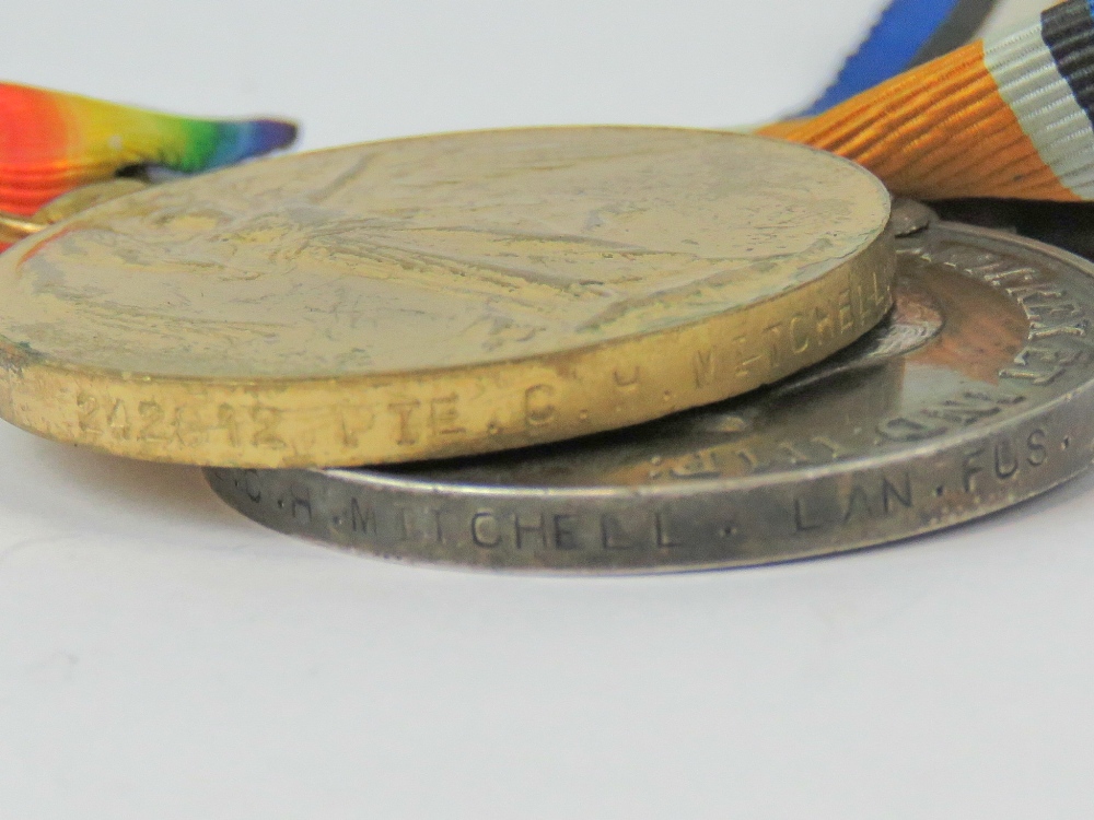 A WWI War and Victory medal group, inscribed for PTE. C.H. Mitchell Lan.Fus. - Image 3 of 3