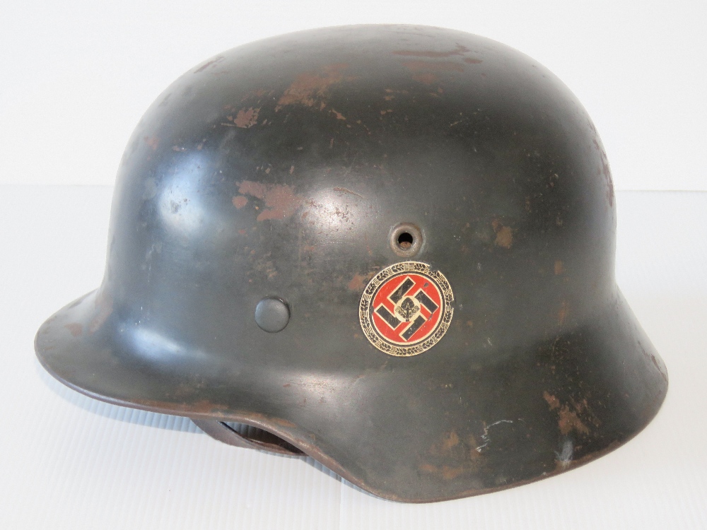 A WWII German RAD Party helmet, later painted having applied double decal,