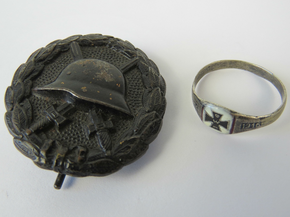 A WWI German 'Black' Wound badge, and a white metal and enamel 1914-16 ring stamped 800. Two items.