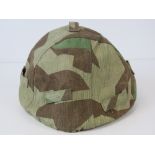 A WWII German camo helmet cover.