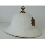 A Royal Marines Offices Pith helmet, officers badge to front, leather label within.