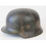 A WWII German helmet, later stripe camo