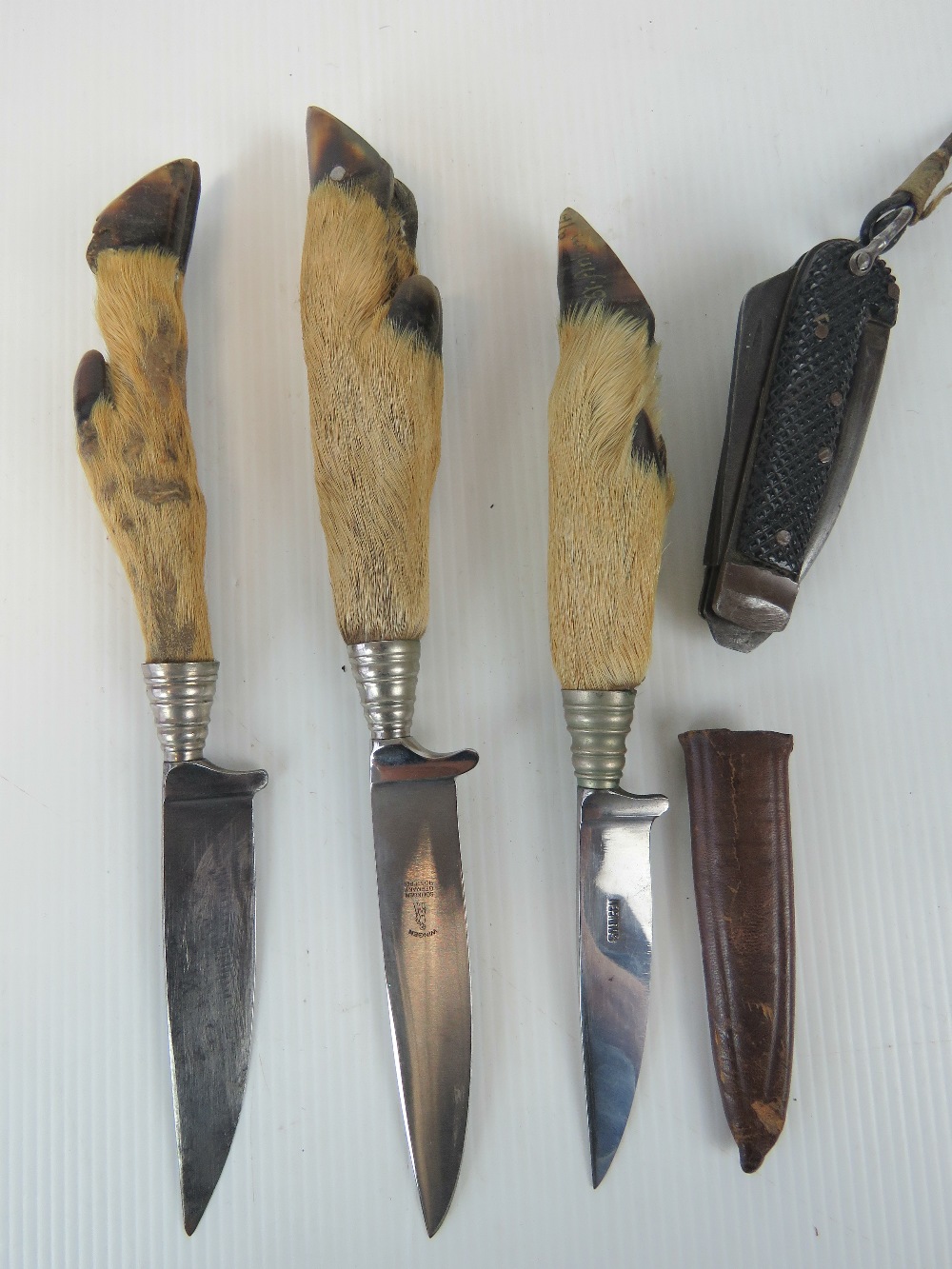 Three hunting knives with deer slot hand