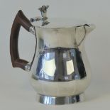 A heavy HM silver hot water pot with wooden handle, standing 14.