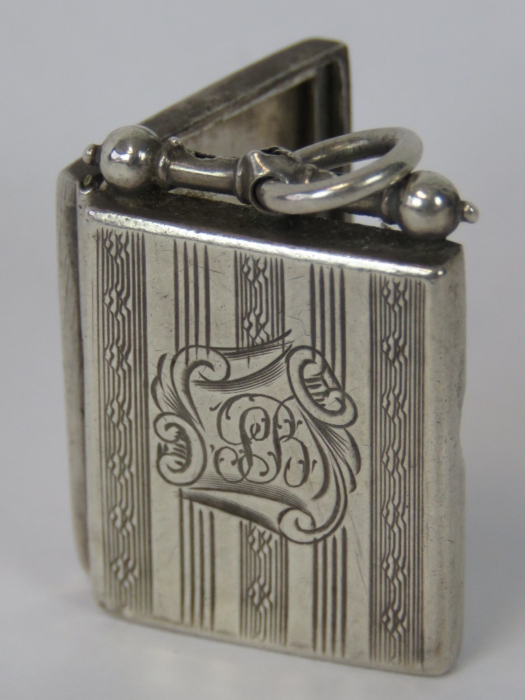 A HM silver locket of rectangular form, Birmingham 1938, 3.5cm including bale. - Image 2 of 3