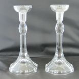 A pair of Orrefors glass candlesticks, with faceted knopped stems tapering to octagonal bases,