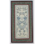 An Oriental embroidery on silk, cream ground with blue floral decoration upon, green and red border,