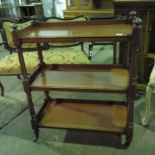 A smart Victorian three teir buffet trolley raised over ceramic casters.