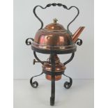 A small copper kettle, complete with copper spirit burner and iron stand, 27cm high overall.