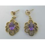 A pair of 9ct gold amethyst earrings, each with central oval amethyst of good purple hue, approx 0.