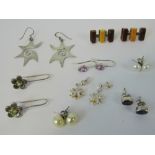 A quantity of assorted silver earrings including; pearl studs, geometric amber earrings,