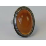 A silver and amber cabachon ring, indistinct hallmarks probably Russian,