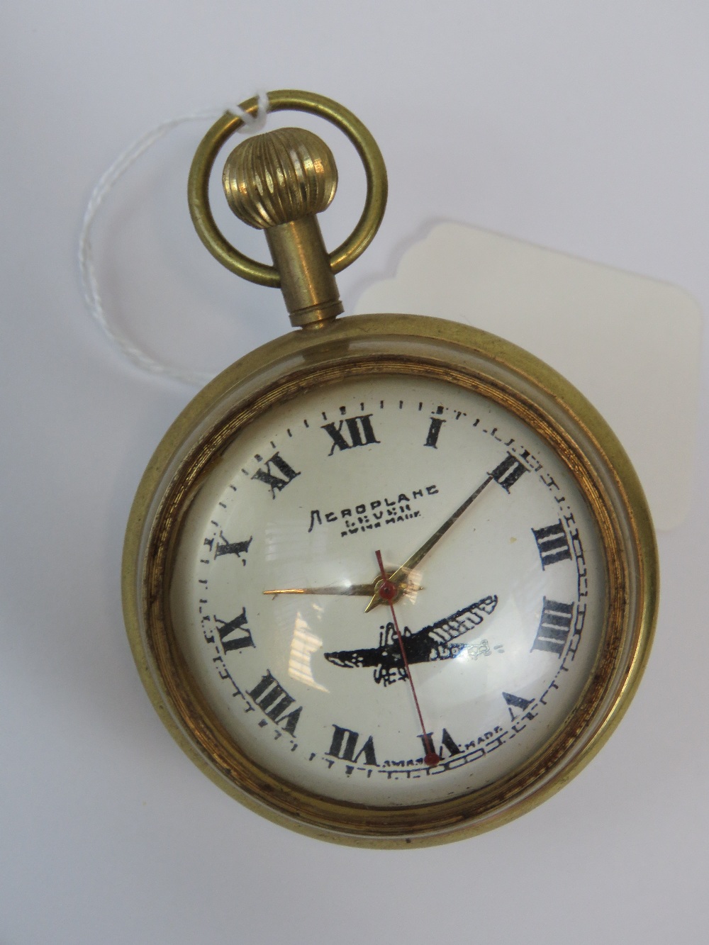 A brass cased 20th century spherical pocket watch marked 'Aeroplane Livre' to the face and