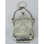 A delightful HM silver purse, complete with carry chain and tan leather interior,
