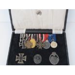 A WWII German Officers Panzer badge and medal group in presentation box. Nine items.