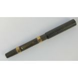 A vintage brown hardened rubber Watermans 52 'self-filler' fountain pen,