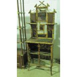 A delightful Victorian bamboo and chinoiserie style hall stand having bevel edged mirror flanked by