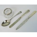 A HM silver spoon, London 1895, a fruit knife and a butter knife each with HM silver blade,