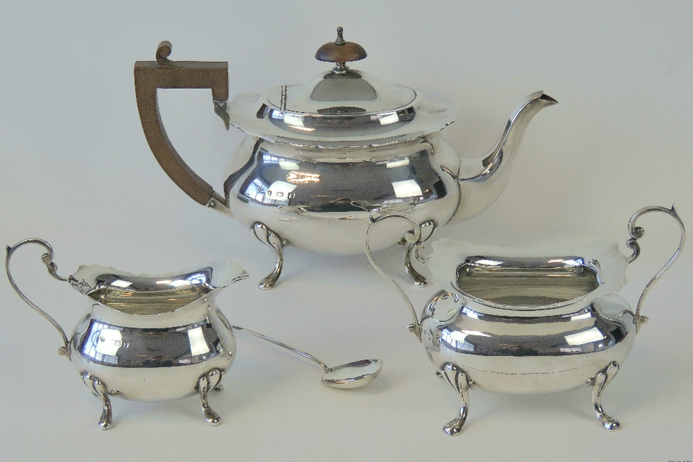 A HM silver three piece tea service comprising teapot, milk jug and sugar bowl,