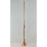 A copper and brass coaching horn, complete with silken carry strap, 124cm long.