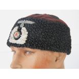 A German lambs wool and velvet skull cap with two Third Reich badges.