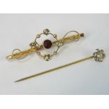 A 9ct gold bar brooch with pearl and garnet floral design, stamped 9ct, 2g.