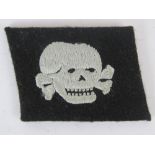 A WWII German SS Deaths Head collar patch, removed from uniform.