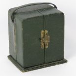 A vintage green leatherette double door freestanding watch bow with loop handles and engraved gilt