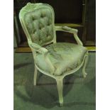 A single cream painted 20th century Continental style button back salon chair.