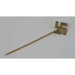 A reproduction yellow metal WW2 Nazi Swastika stick pin (6.2cm long).