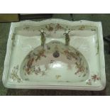 A vintage transfer printed decorative ceramic wall mounting sink, brass taps, slightly a/f.