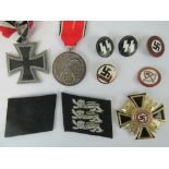 Ten German medals and badges including; reproduction Iron Cross and NSDAP badge.