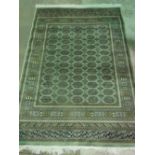 A green ground bokhara rug; 190cm x 140cm.