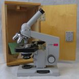 A late 20th century Russian biological microscope, with wooden case and instruction manuals; a/f.
