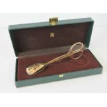 A pair of WMF 24k Gold plated cake tongs, boxed.