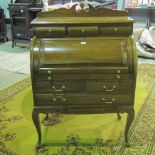 A 20th century mahogany cylinder bureau on stand comprising three drawers over cylinder lid,