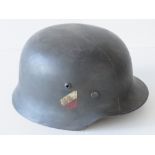 A WWII German Army helmet, later painted having applied double decal, leather lining and chin strap.