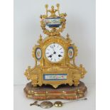 A highly ornate gilt brass Japy Frères mantel clock having hand painted ceramic decorative panels